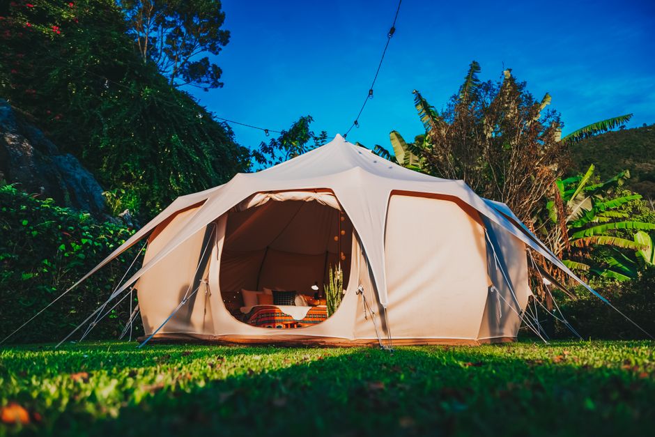 Experience luxury glamping in a beautifully set outdoor tent, perfect for a serene getaway.
